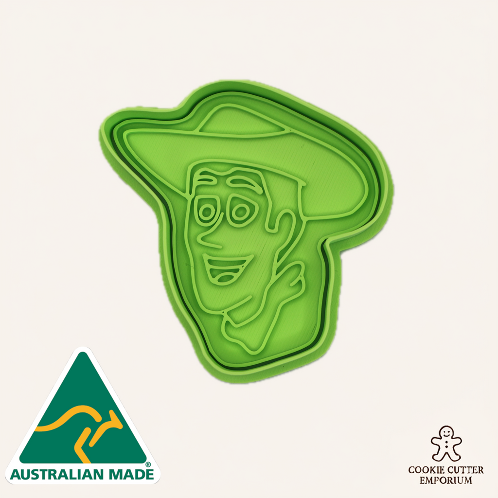 Green cookie cutter shaped like a face with a hat on a white background, featuring 'Australian Made' and 'Cookie Cutter Emporium' logos.