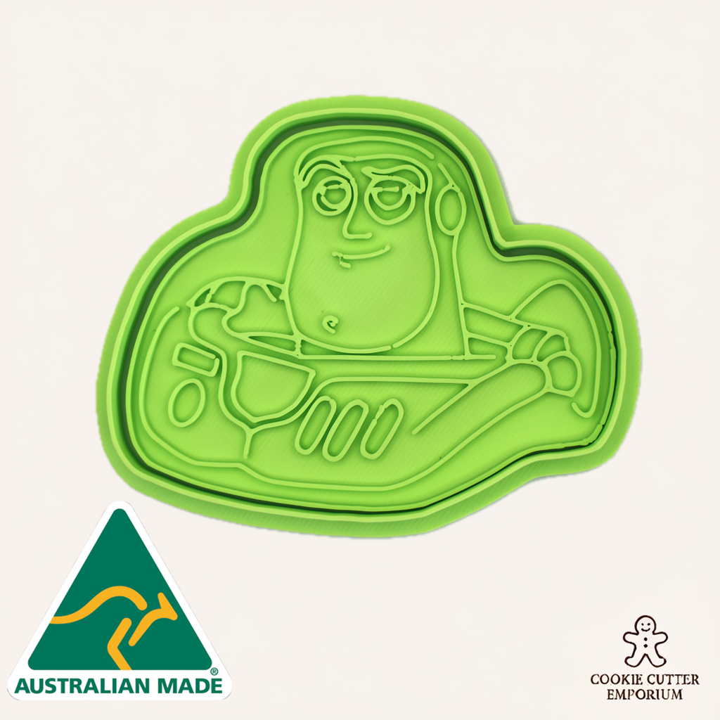 Green cookie cutter shaped like a space hero character, featuring 'Australian Made' and 'Cookie Cutter Emporium' logos.