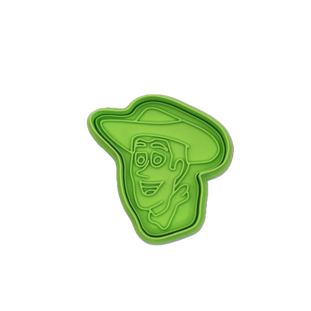 Green cookie cutter with a face design on a white background