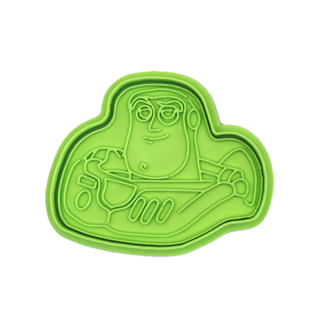 Green cookie cutter shaped like a space hero character.