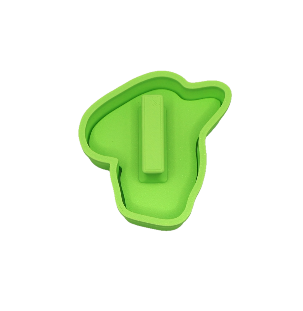 Green cookie cutter shaped like a character's head on a white background with a handle