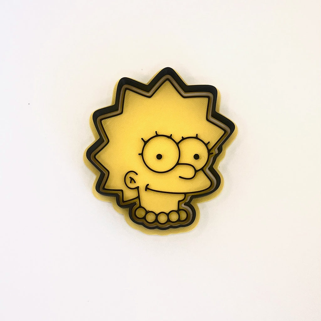 クラシックな漫画風のツンツンヘアの女の子キャラクターのクッキー型とフォンダンスタンプ – レトロなファミリーパーティー