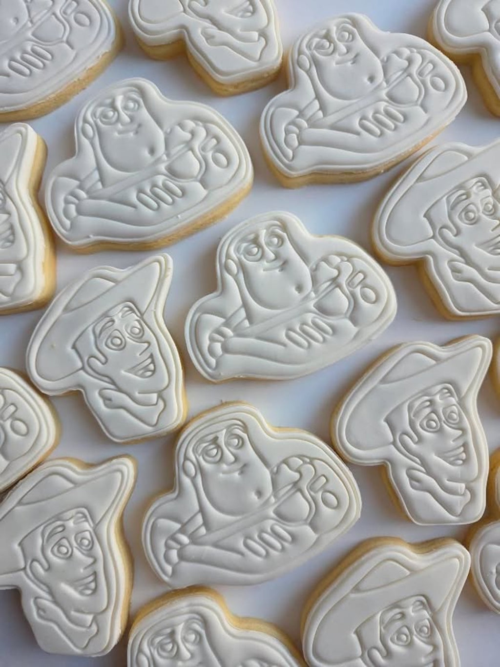 Decorative cookies with cartoon character faces on a white surface