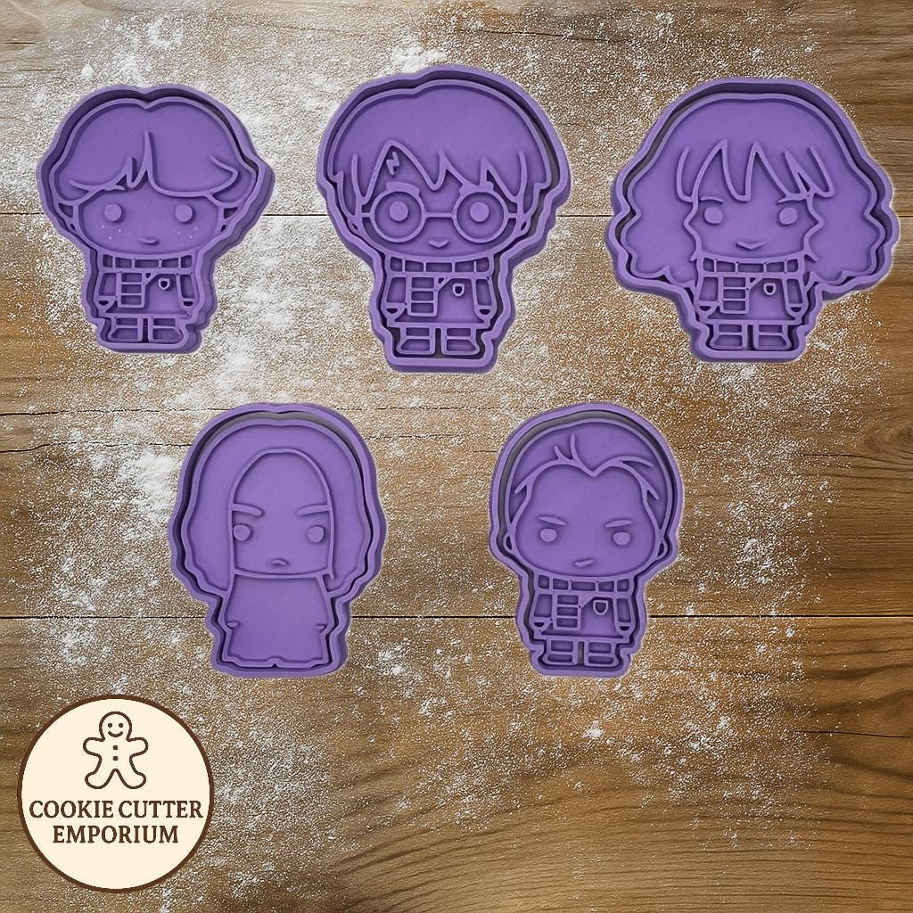 Set of purple cookie cutters shaped like cartoon characters on a wooden surface with a rolling pin and checkered towel.