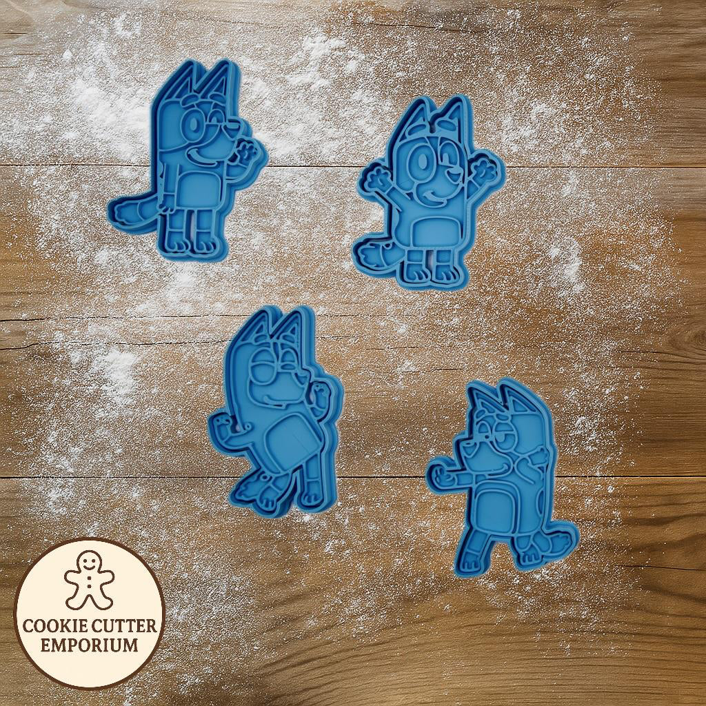 Set of blue cookie cutters shaped like cartoon characters on a wooden surface with a rolling pin and checkered cloth.