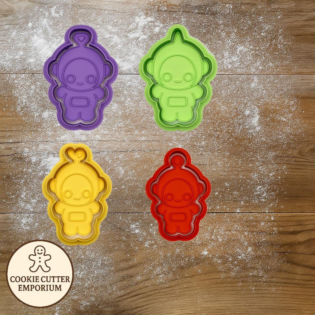 Colorful cookie cutters on a wooden surface with a rolling pin and checkered cloth.