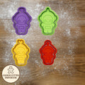 Colorful cookie cutters on a wooden surface with a rolling pin and checkered cloth.